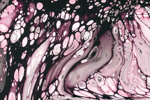 Vibrant abstract acrylic pour art with pink and black fluid patterns, showcasing dynamic flow.