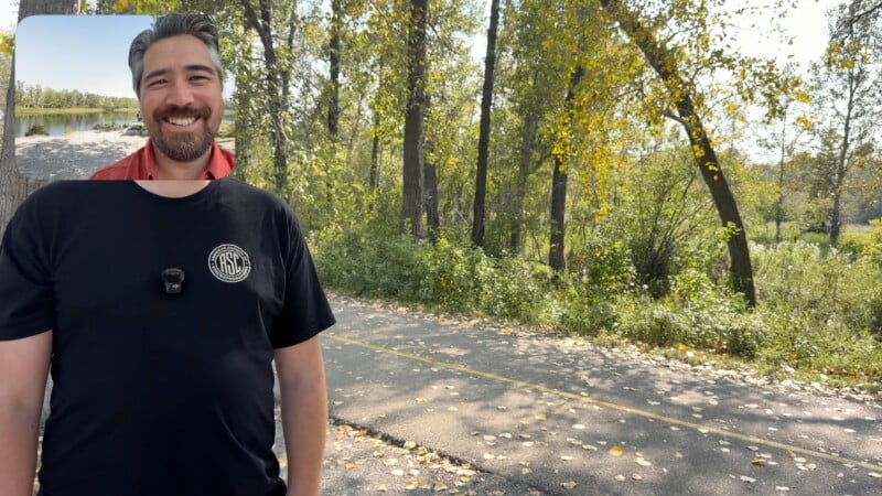 A smiling man in a black t-shirt stands on a sunlit wooded trail with trees and fallen leaves. In the top left corner, there's a small inset photo of him by a lake.